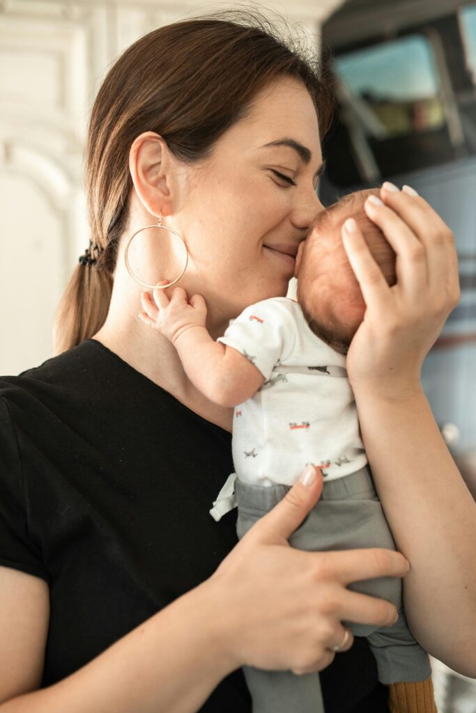 A tender moment of a mother lovingly embracing her newborn baby indoors.