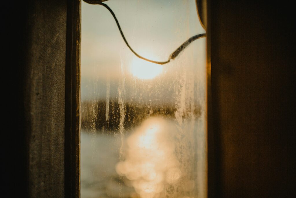 Captivating view through a rustic window, showcasing a serene sunset over Istanbul.